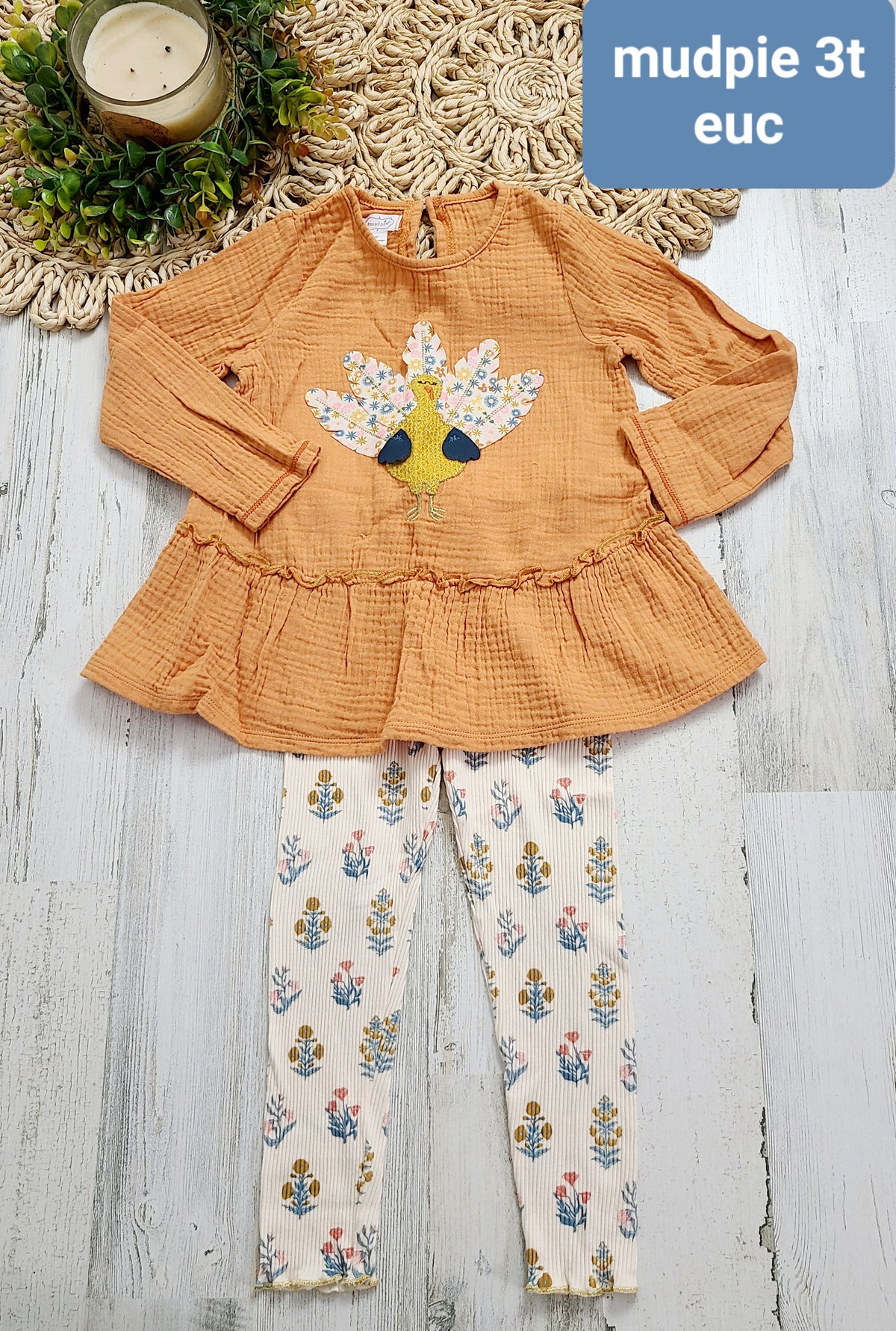 orange top with floral turkey feathers mudpie