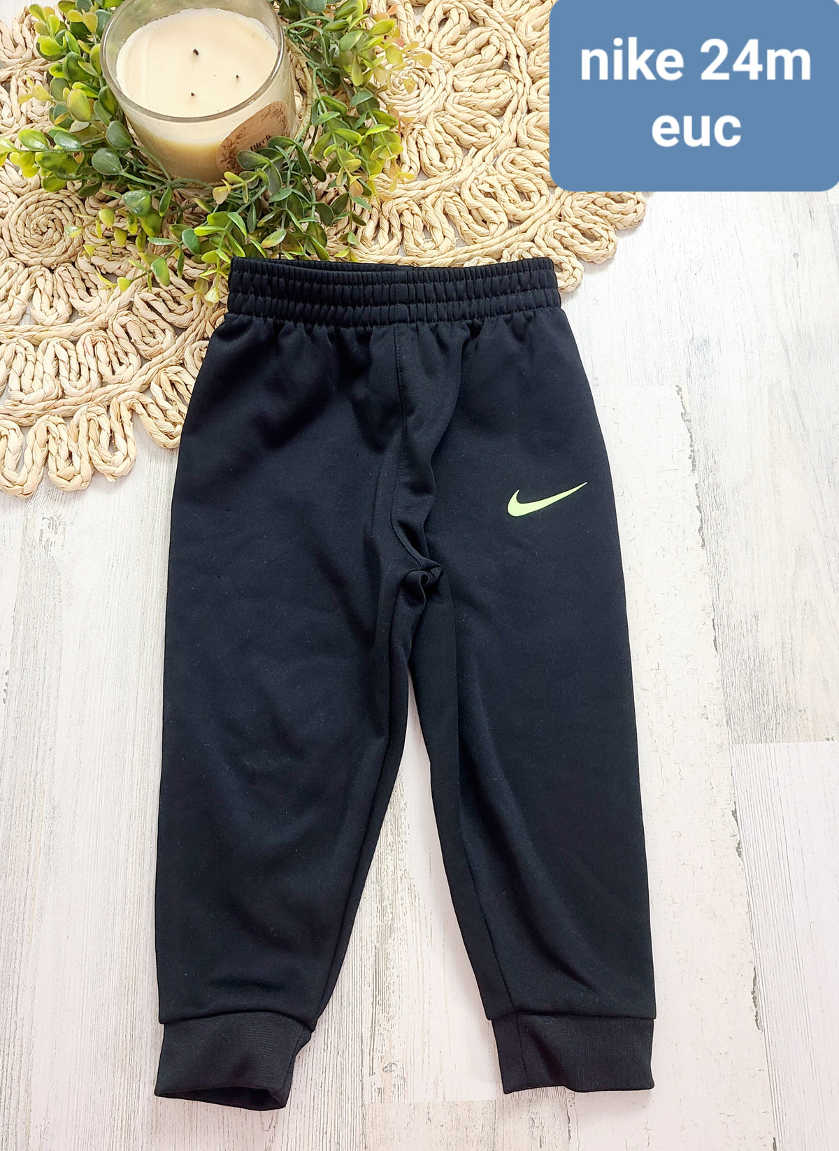 black joggers 24m yellow nike logo