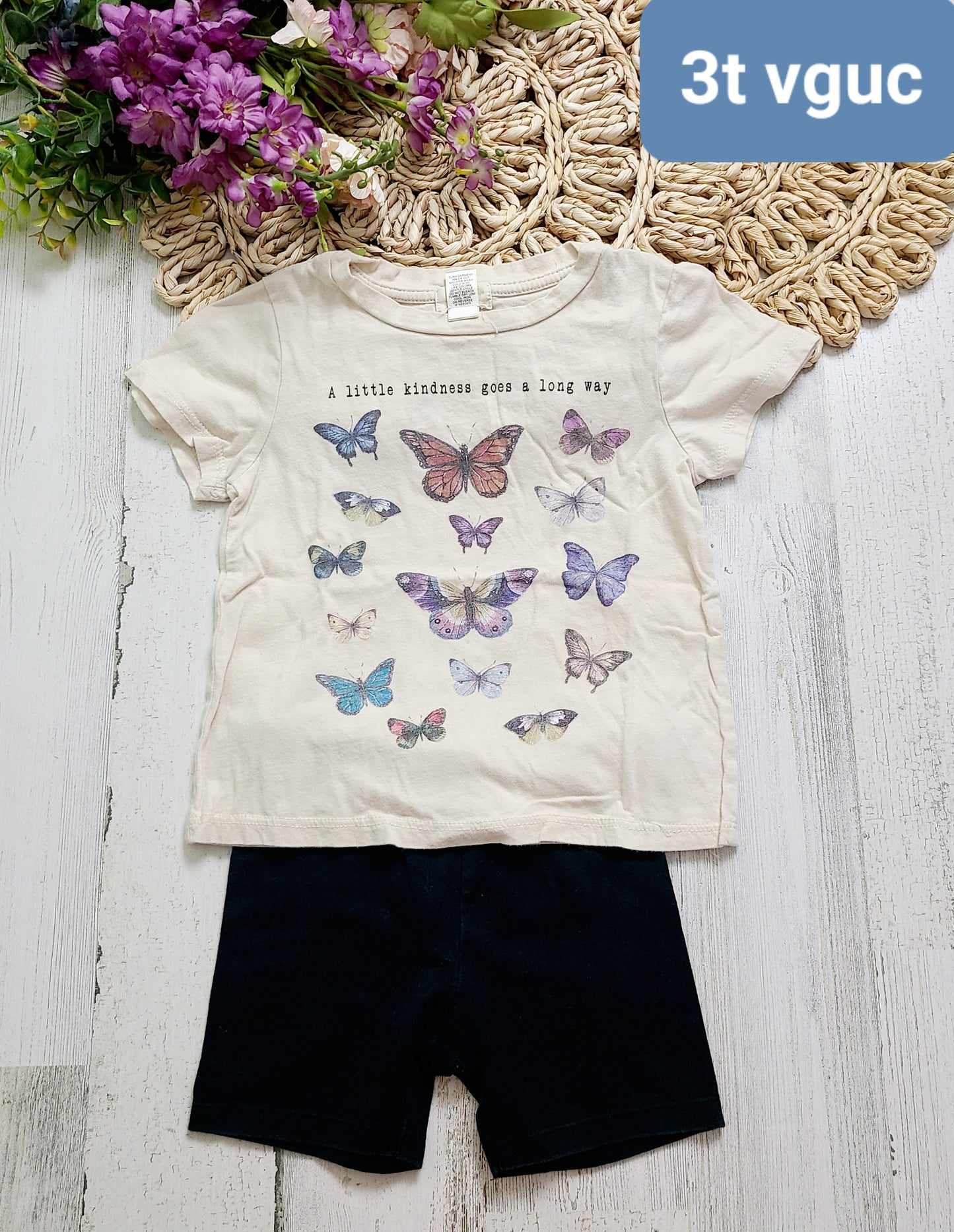 butterfly tee and black shorts